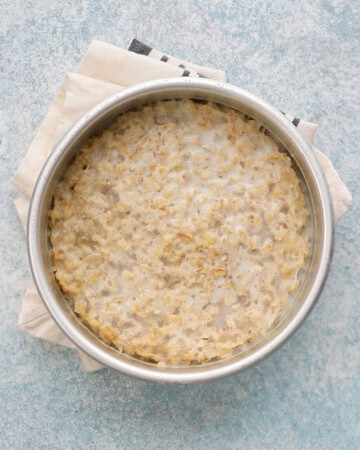 cooked oatmeal in a round metal pan.