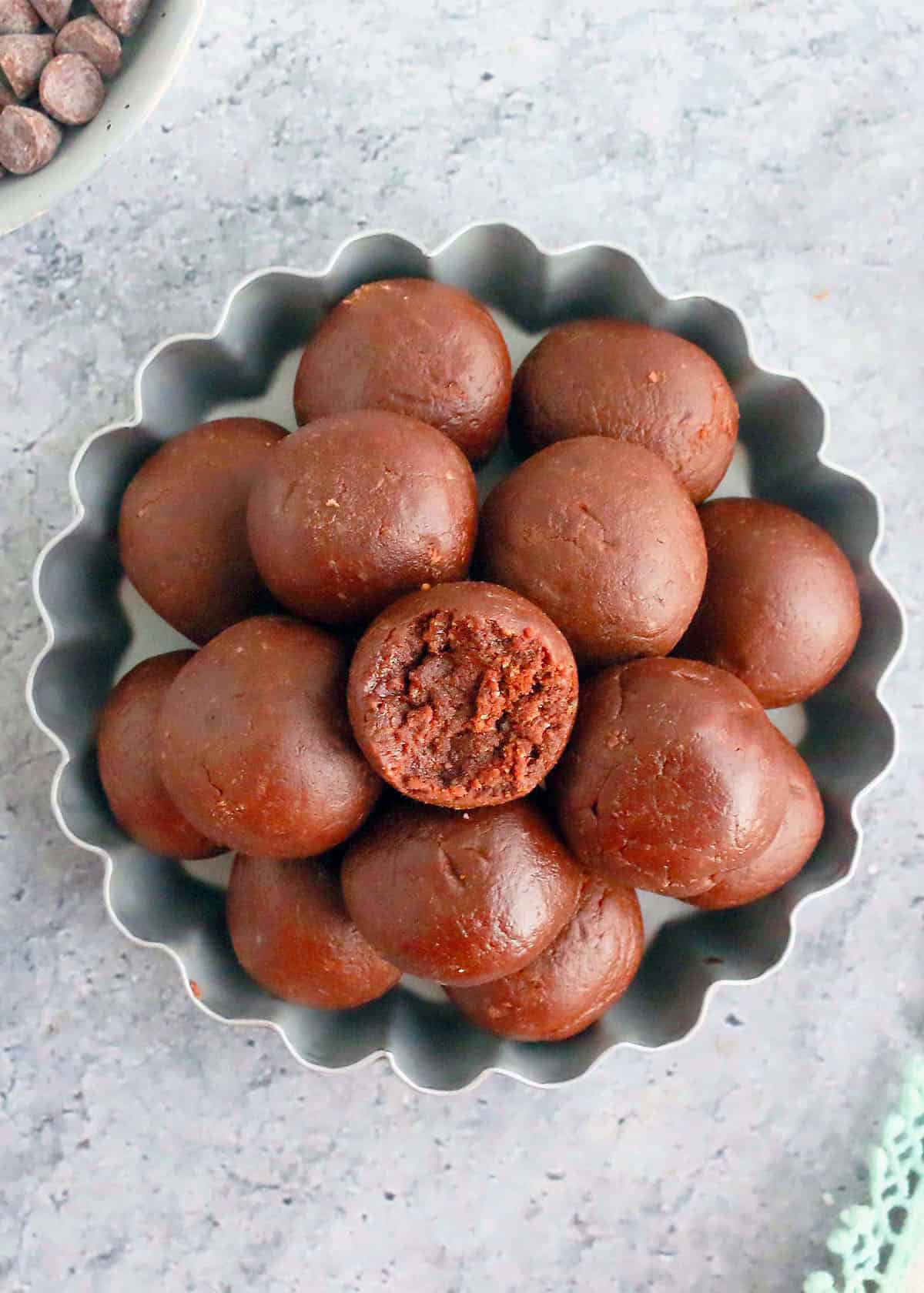 brown chocolate balls piled high on a fluted metal plate.