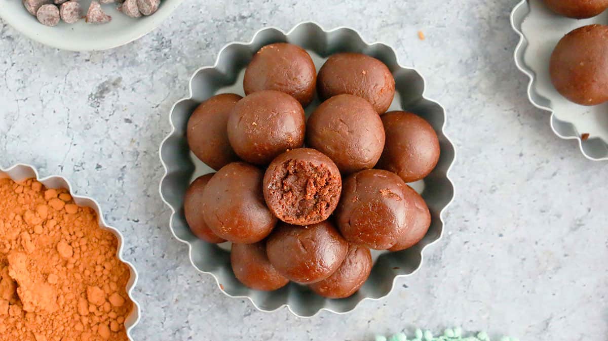 brown chocolate balls piled high on a fluted metal plate.