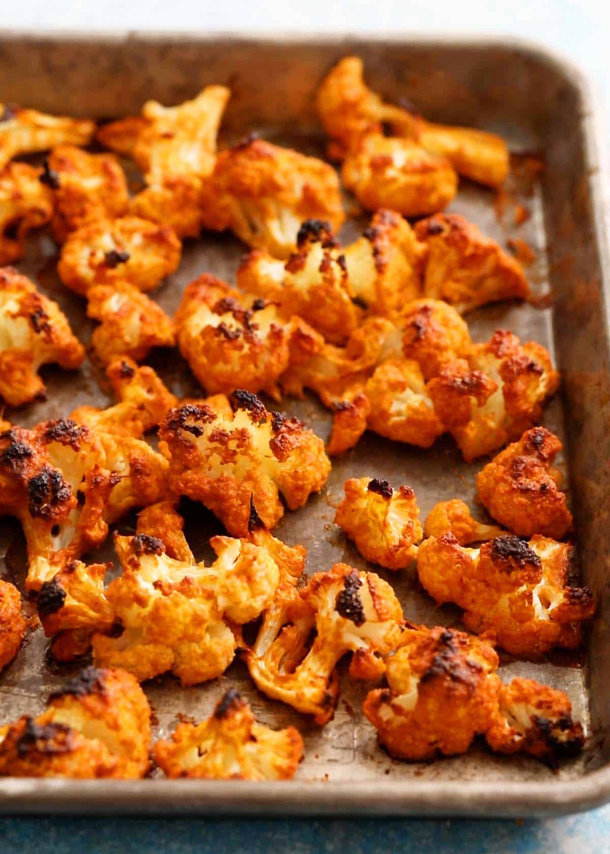 tandoori cauliflower in a metal sheet pan.