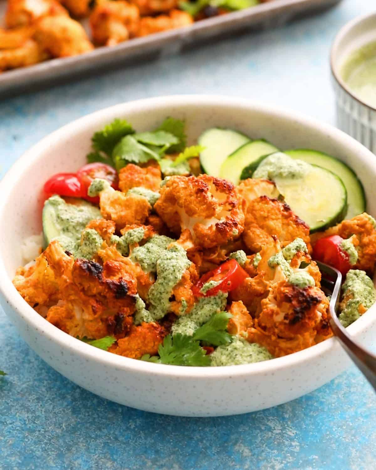 tandoori cauliflower bites in a white bowl.