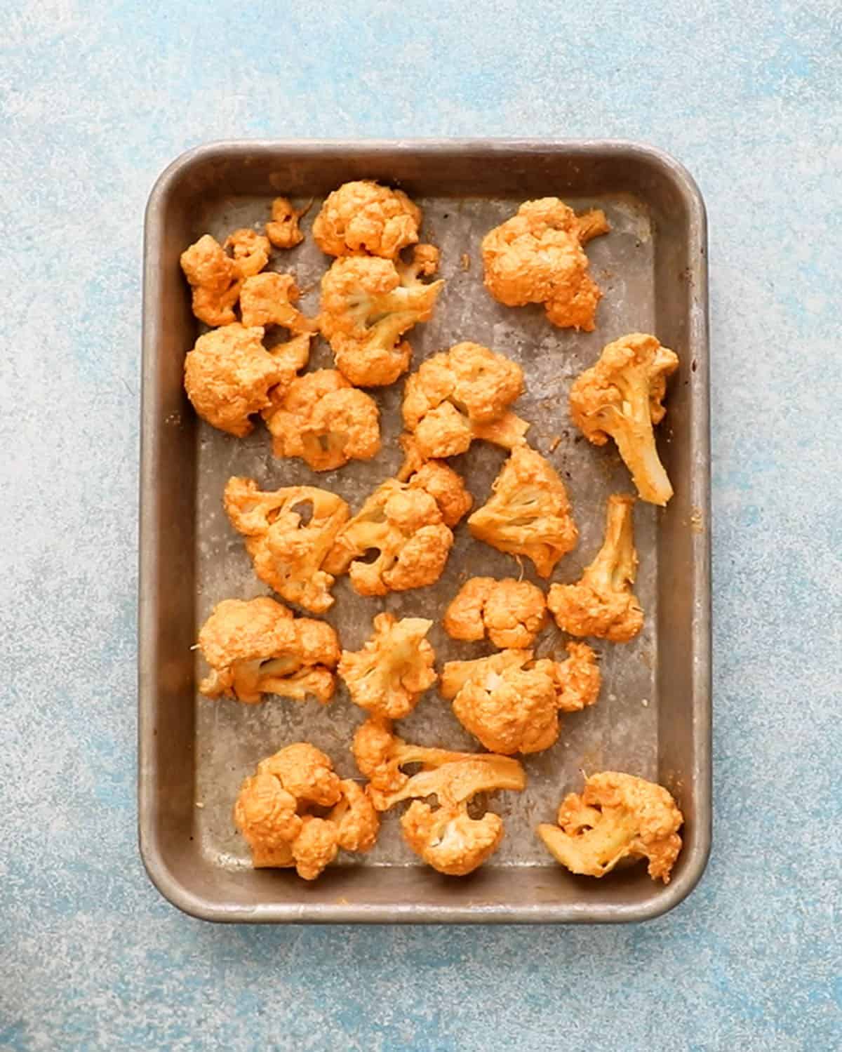 tandoori cauliflower in a metal sheet pan.