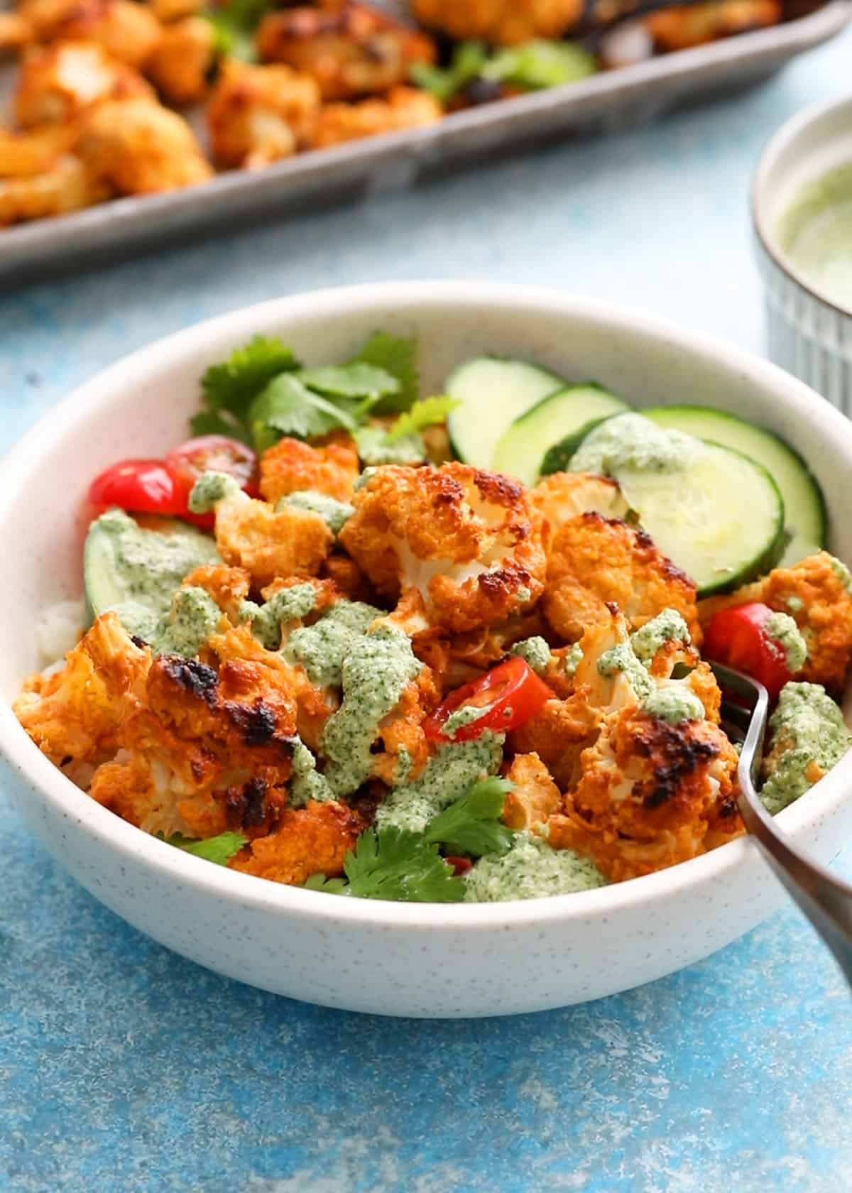 tandoori cauliflower bites in a white bowl.
