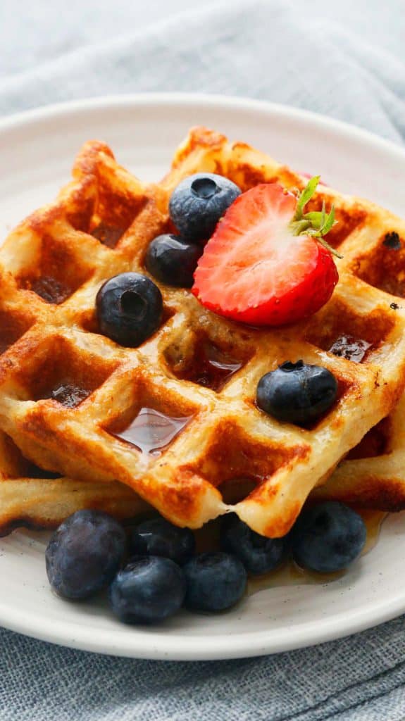 egg free waffles on a plate with maple syrup