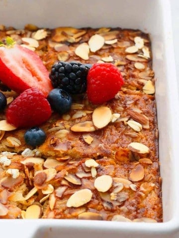 gluten free baked oatmeal with bananas topped with fresh fruits.