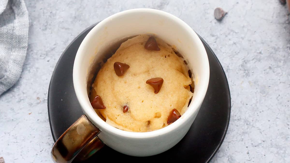 vanilla chocolate chip vegan mug cake in a white coffee mug.
