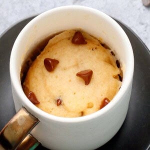 vanilla chocolate chip vegan mug cake in a white coffee mug.
