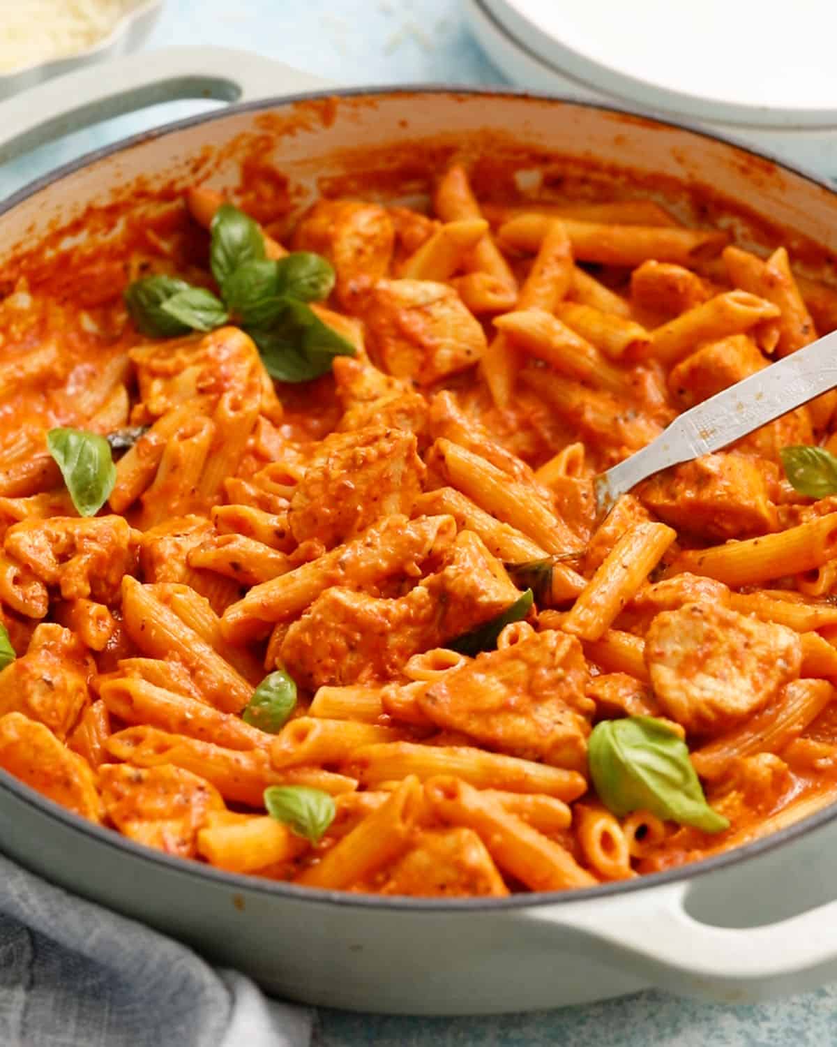 chicken vodka pasta in a white pan.