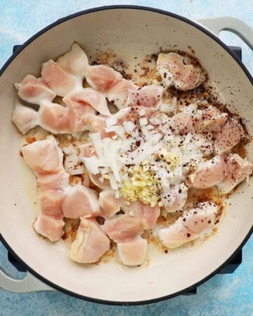 chicken alla vodka cooking in a white pan.