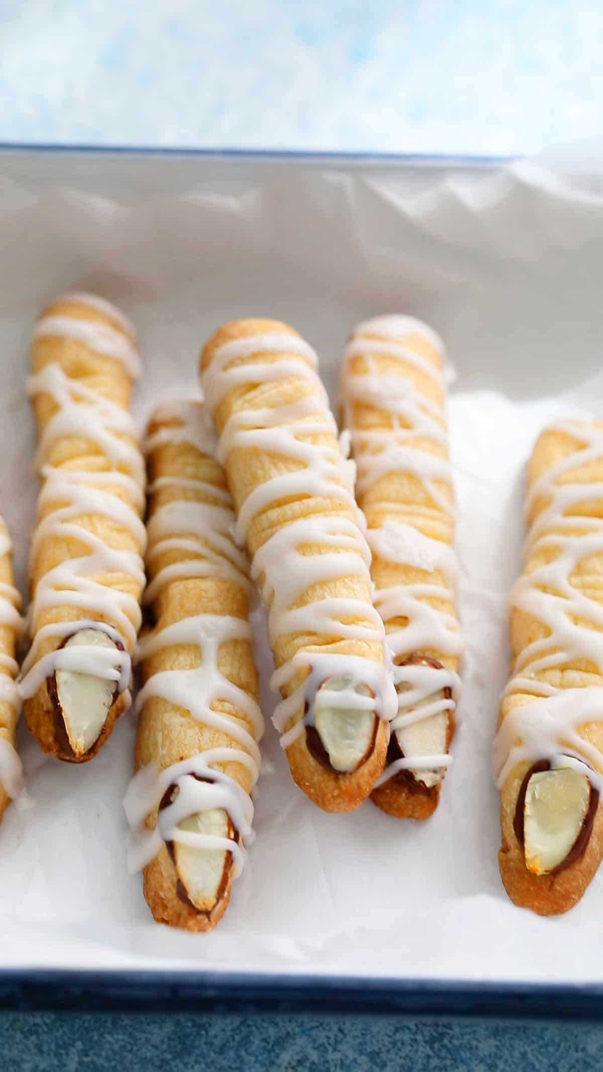 finger shaped cookies placed in a white tray. 
