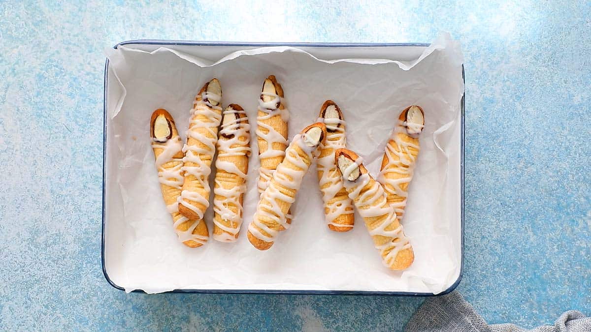 finger shaped cookies placed in a white tray. 