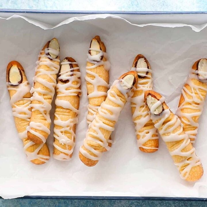 finger shaped cookies placed in a white tray lined with parchment.