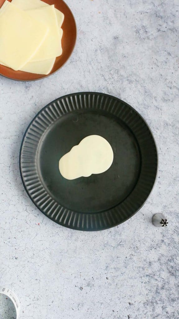 black plate with cheese shaped skull