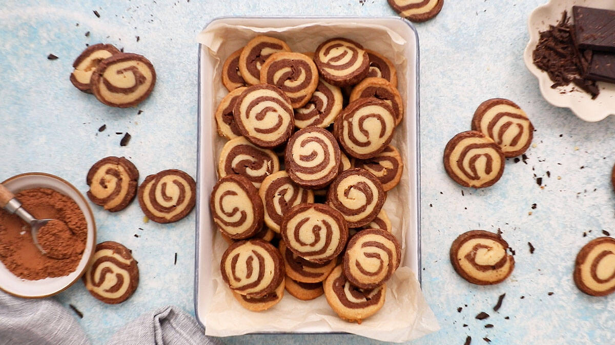 chocolate pinwheel cookies in a white tray.
