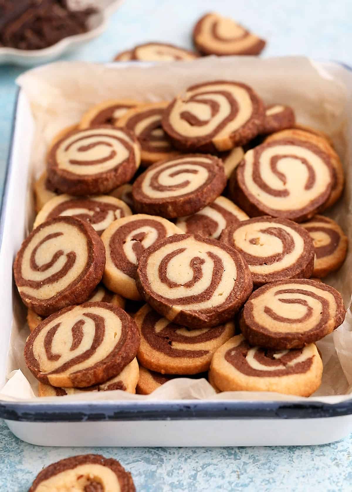 chocolate pinwheel cookies in a white tray.