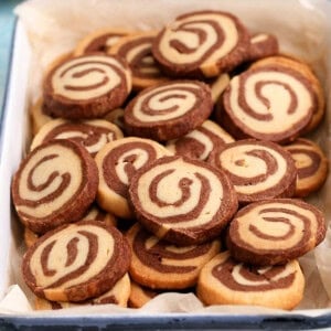 chocolate pinewheel cookies in a white tray.
