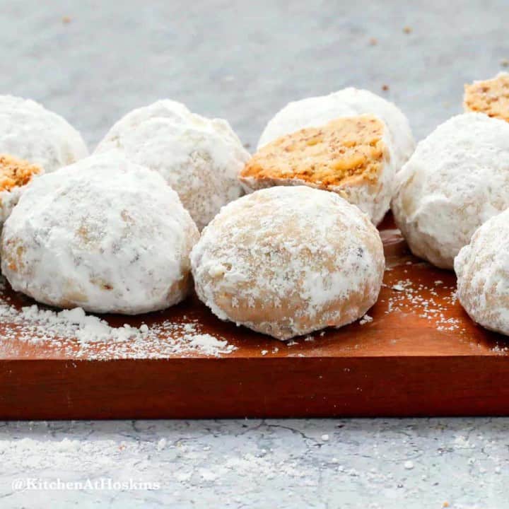 pecan snowball cookies on a board