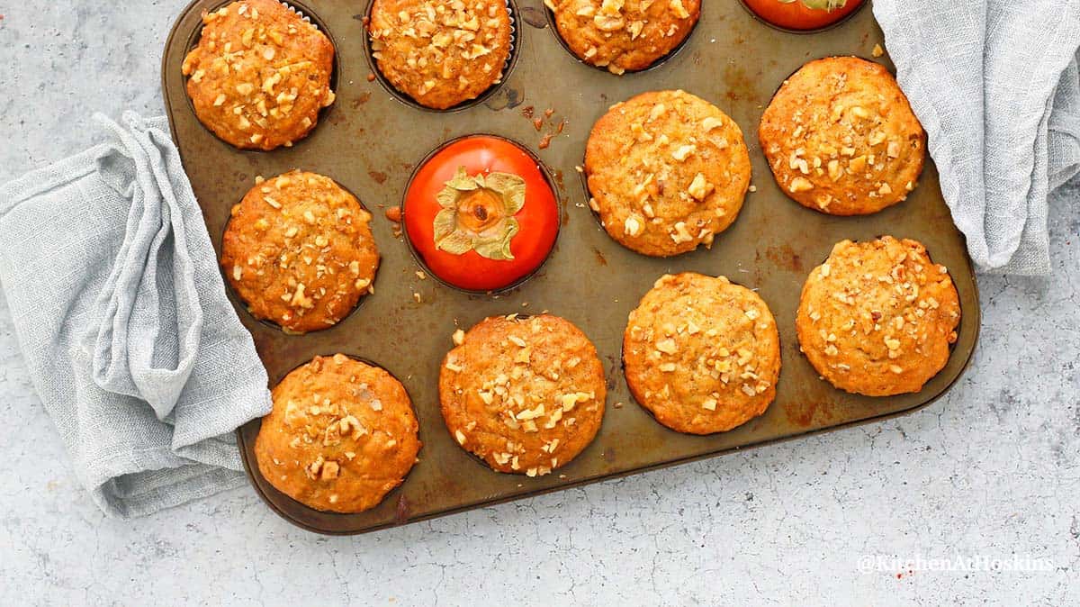 persimmon muffins in a muffin pan. 