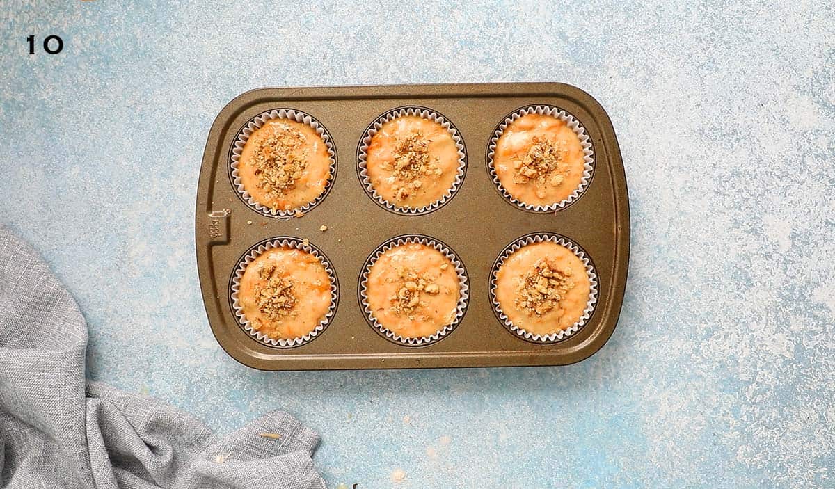 6 cup muffin pan with persimmon muffin batter, ready to be baked. 