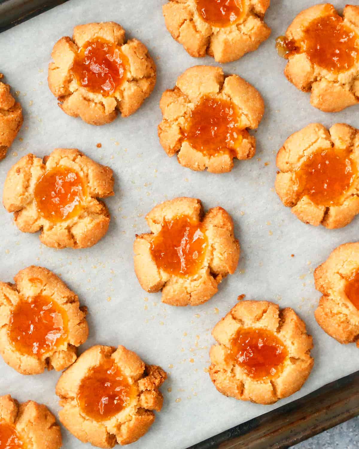 baked almond flour thumbprint cookie dough in a baking sheet.