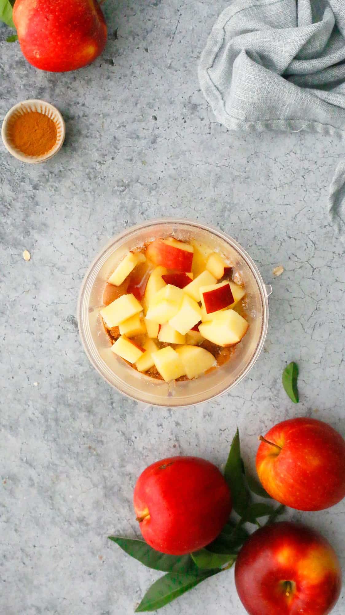 blender with chopped apples along with other ingredients.