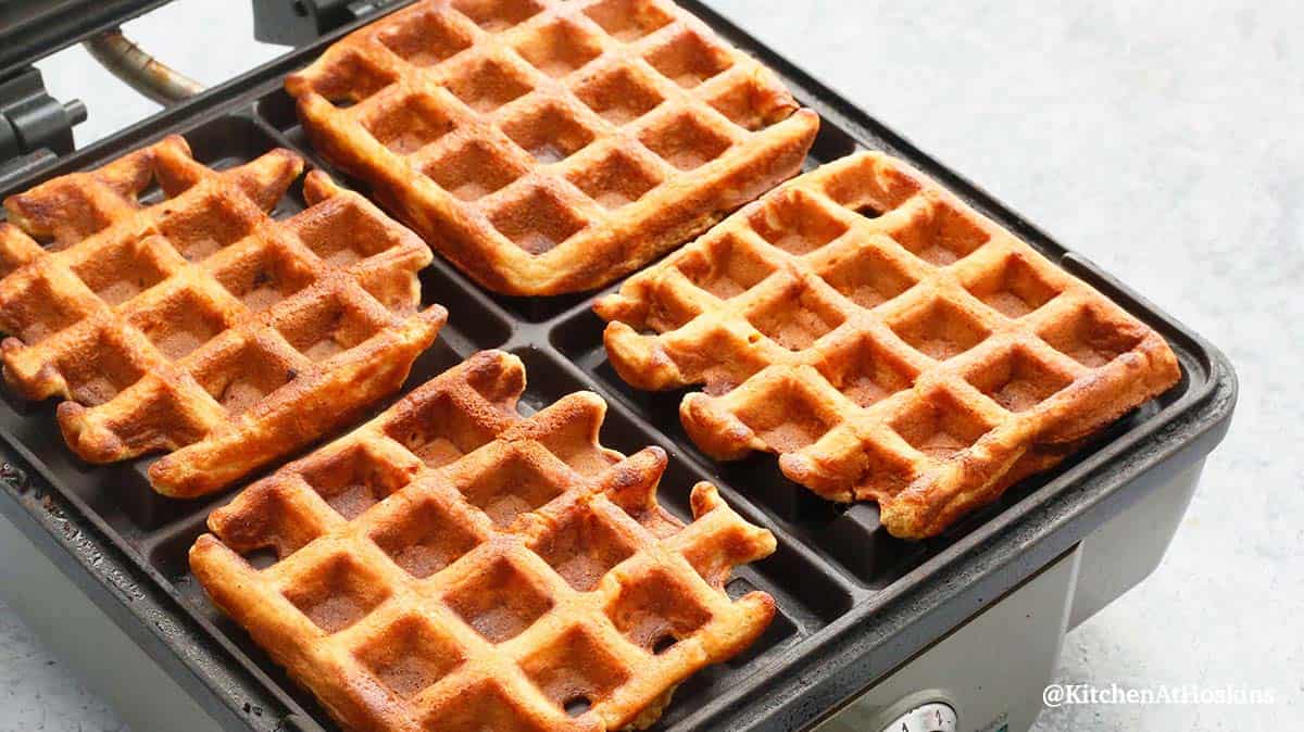 freshly cooked hot waffles in a waffle iron.