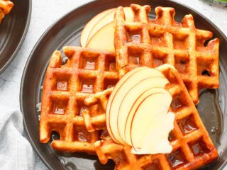 waffles on a plate with apple slices.