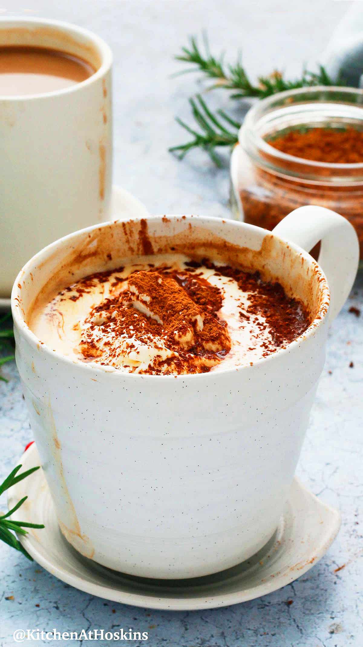 hot mocha latte topped with whipped cream in a white mug.