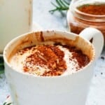 hot mocha latte topped with whipped cream in a white mug.
