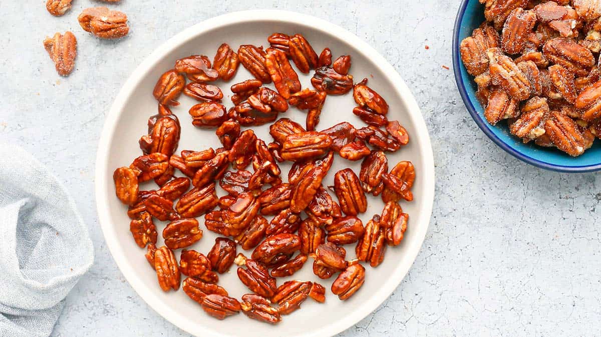 candied pecans in a round white plate.