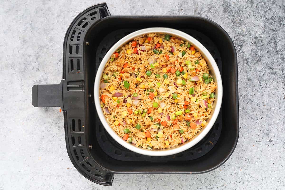 Air fryer basket with fried rice with egg.