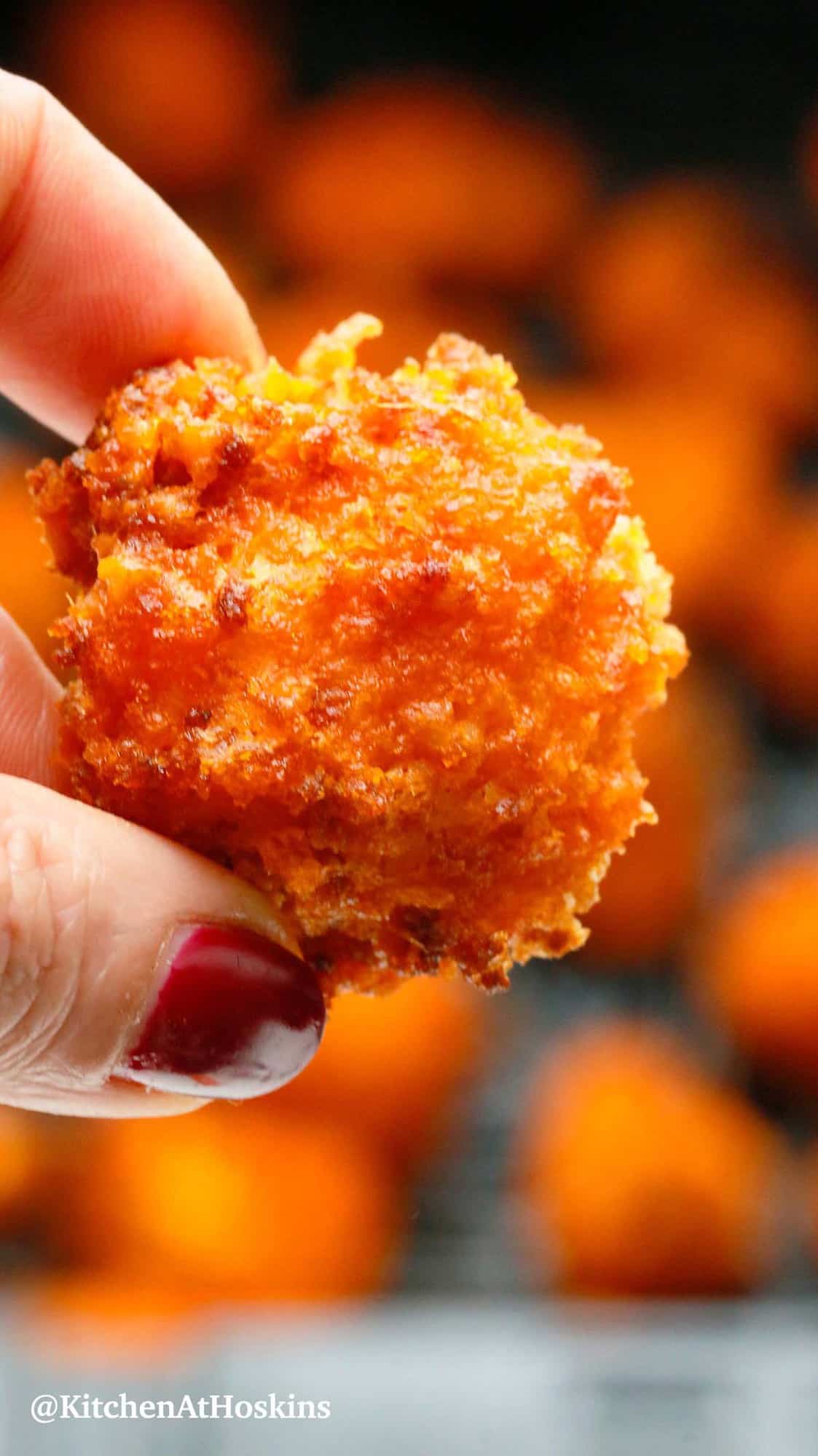 2 fingers holding a cauliflower wing made in air fryer.