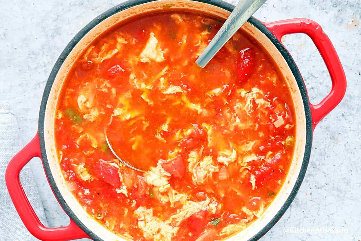 Red saucepan with egg drop tomato soup