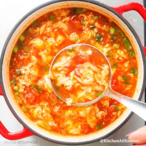 Chinese tomato egg drop soup in a saucepan.