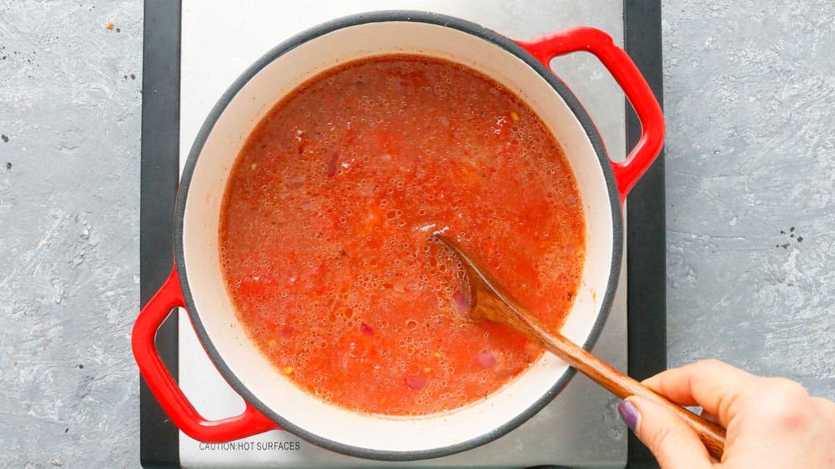 stirring in tomatoes with chicken stock. 