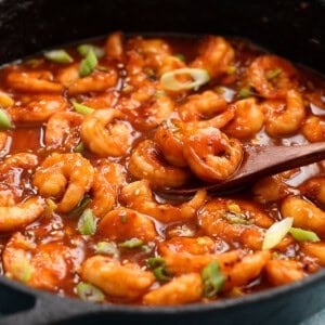 stir fried firecracker shrimp in a black skillet.