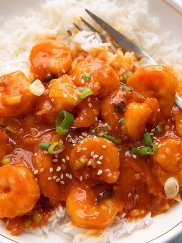 rice and firecracker shrimp bowl with fork.