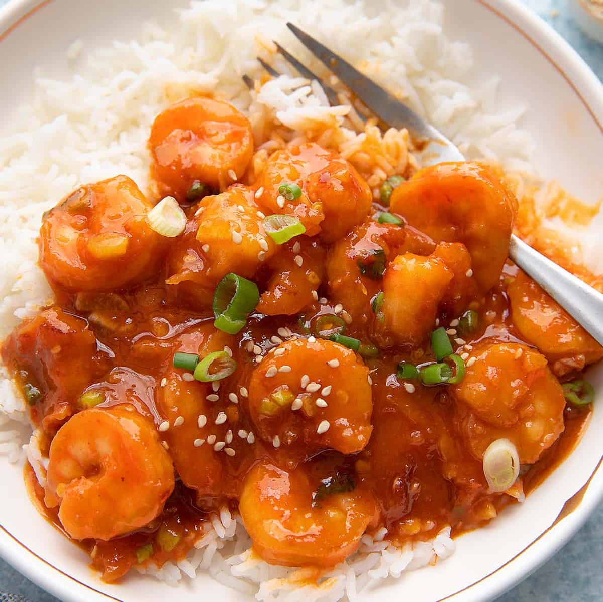 rice and firecracker shrimp bowl with fork.