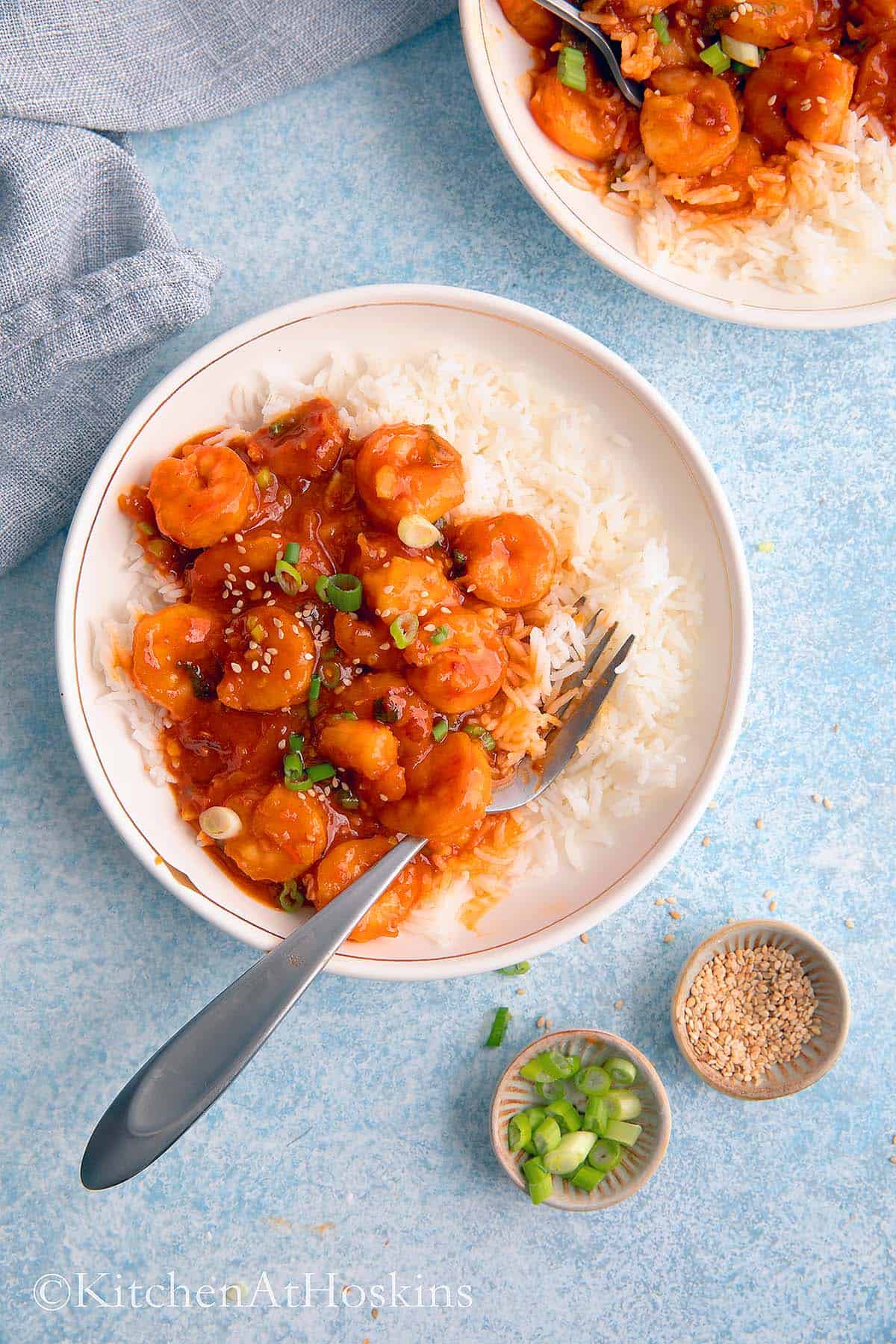 white bowls with firecracker shrimp and rice. 