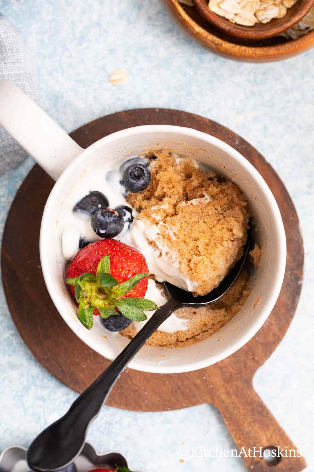 breakfast mug cake with oats topped with yogurt.