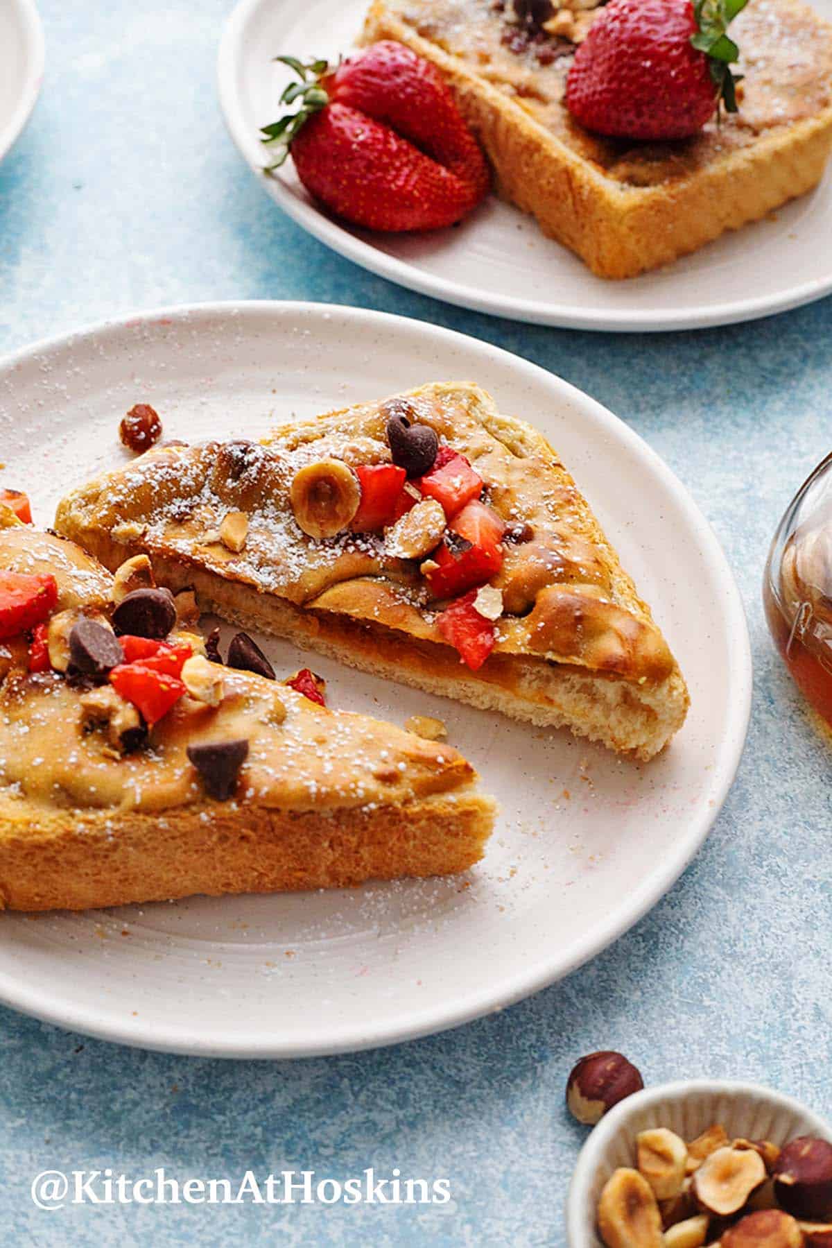 peanut butter toasts topped with strawberries and nuts. 