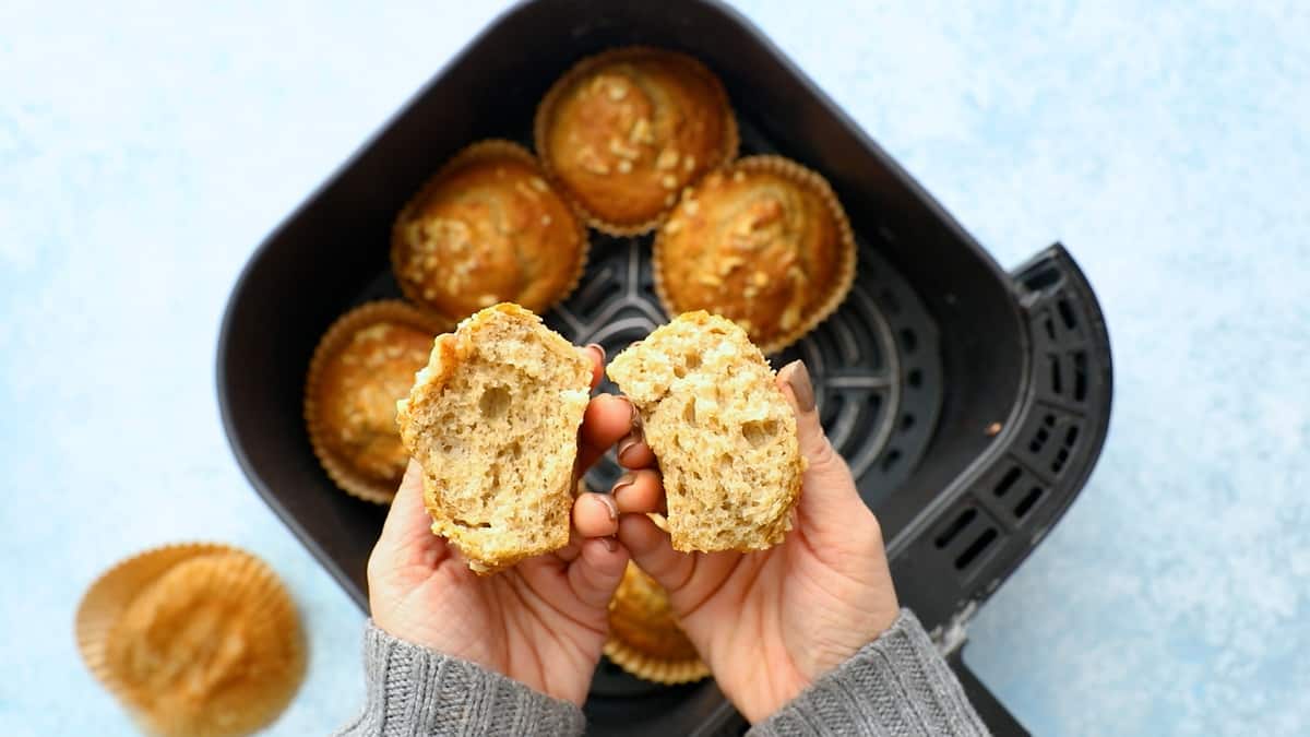 a split banana muffin above an air fryer basket.