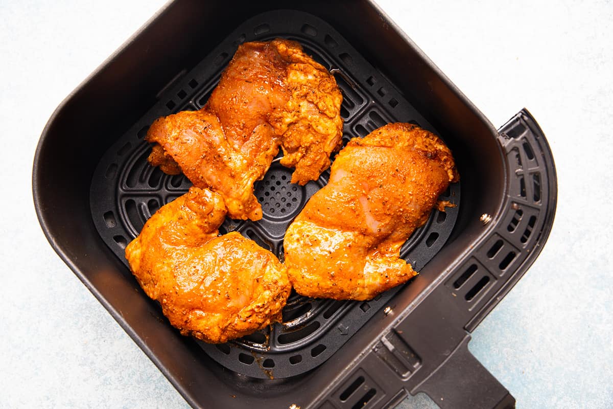 marinated Mexican chicken in an air fryer basket. 