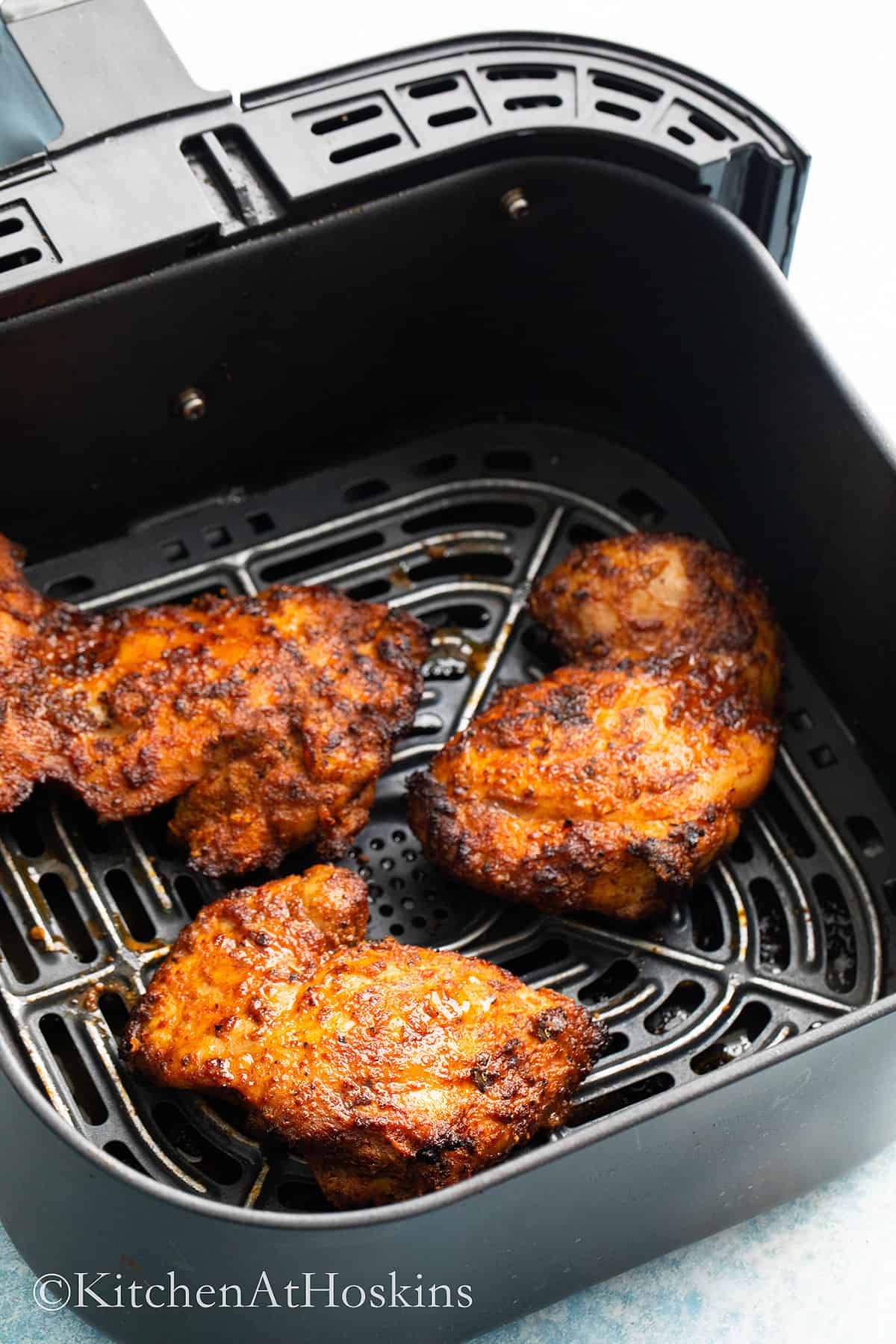 air fryer basket with cooked chicken thighs to make tacos. 
