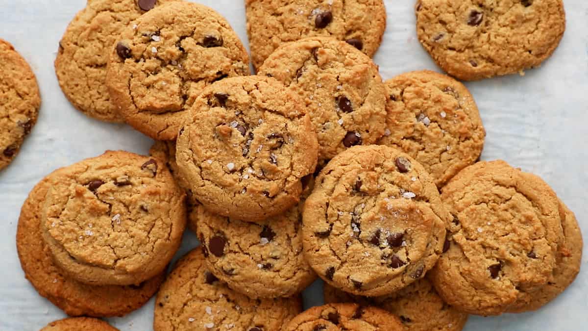 brown peanut butter chocolate chip cookies placed on a white board.