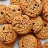 brown chocolate chip cookies placed on a white board.