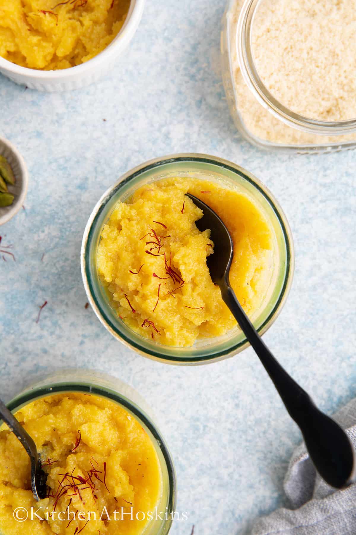 glass jars with almond halwa and black spoon. 