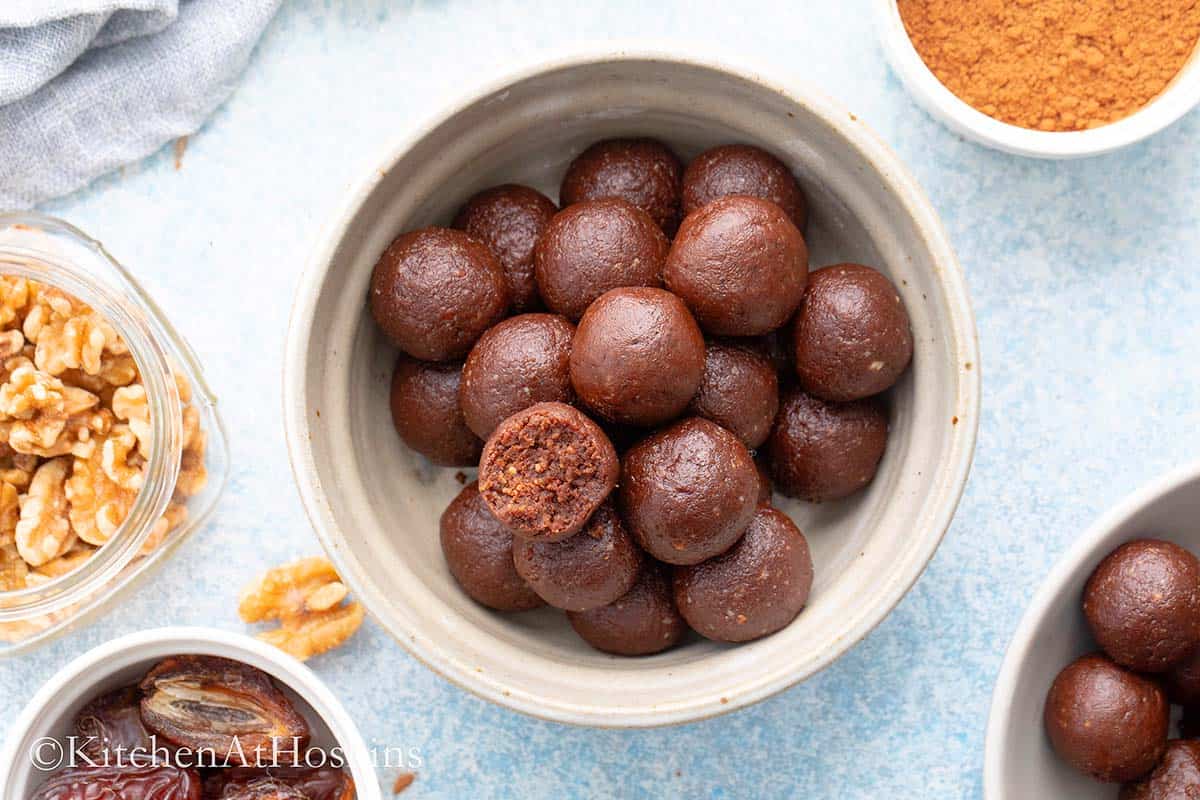 grey bowl with brown date balls.