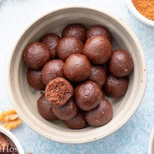 grey bowl with brown date balls.