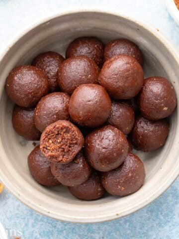 grey bowl with brown date balls.